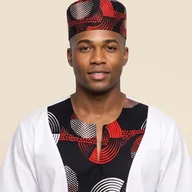 Man wearing a white Ankara print shirt and matching kufi cap